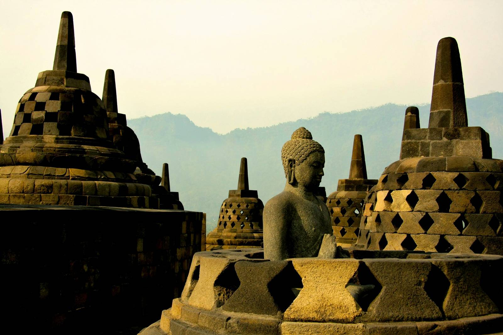 Buddha statue and stupas at Borobudur Temple, Java