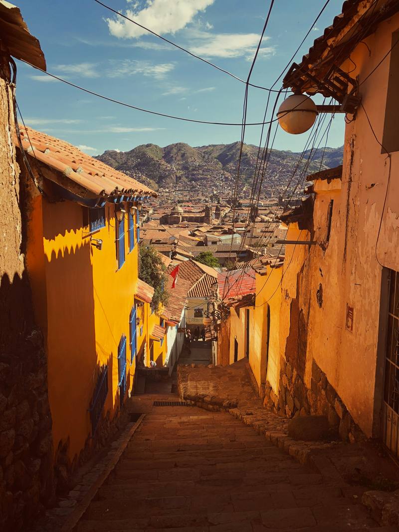 Yellow colonial street in Cusco, Peru, looking over the city