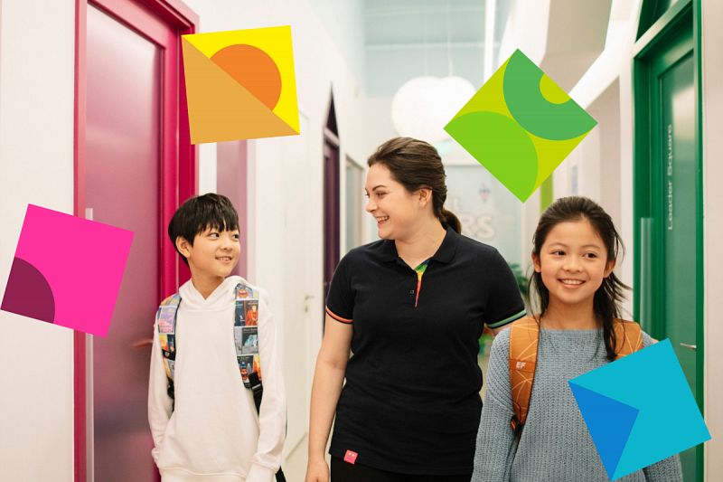 English teacher walking with two students at a school in China