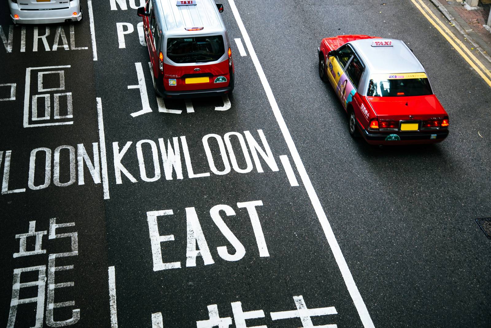 Red Hong Kong taxis on a Kowloon road