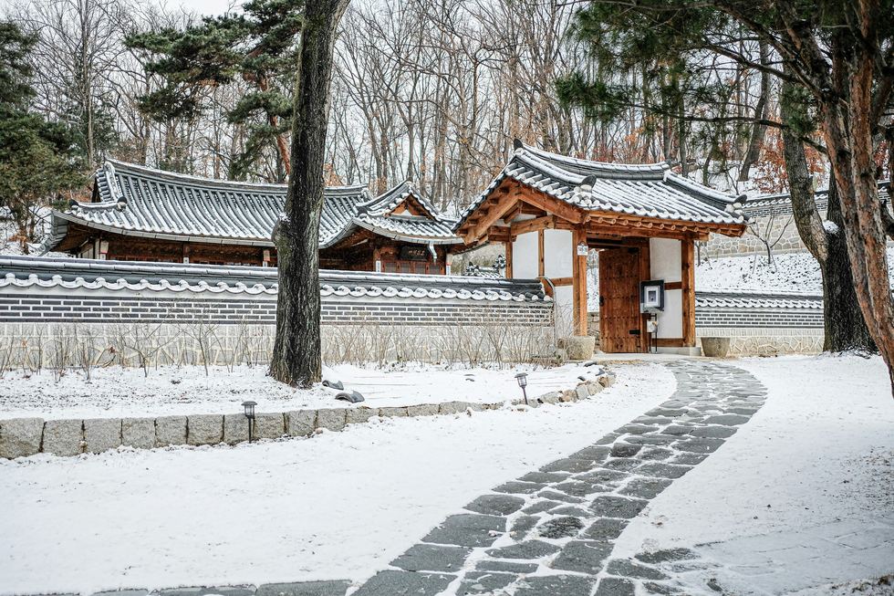 Traditional Korean hanok and gate in winter snow