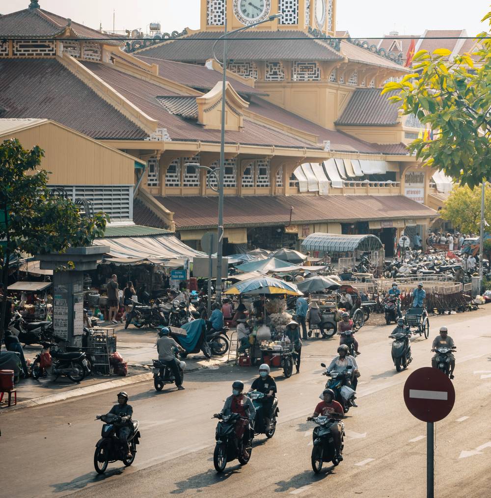 Motorbikes passing Binh Tay Market in Cholon, Ho Chi Minh City