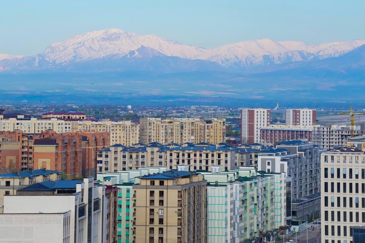 Tashkent apartment blocks with snow-capped mountains behind