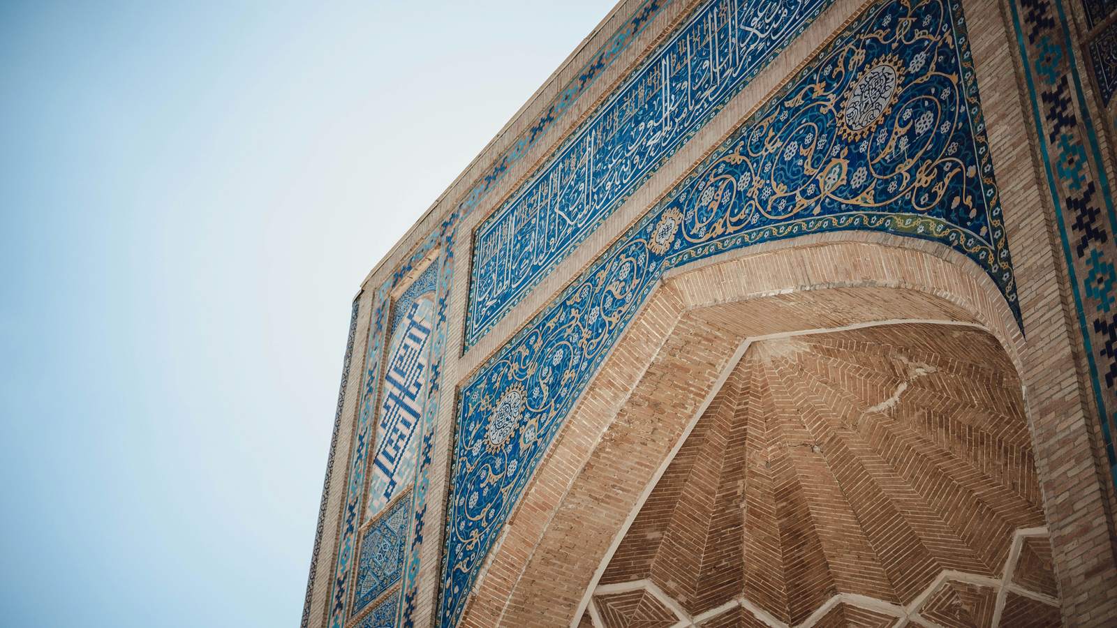 Blue tilework on a madrasa arch in Uzbekistan